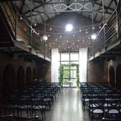 Warm White String Lights hanging in the main room in a zigzagging pattern for a wedding at The Foundry.