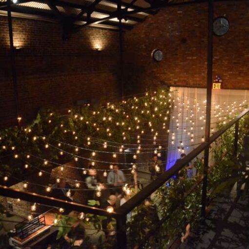 A zigzagging canopy of string lights hanging in the main room at The Foundry.