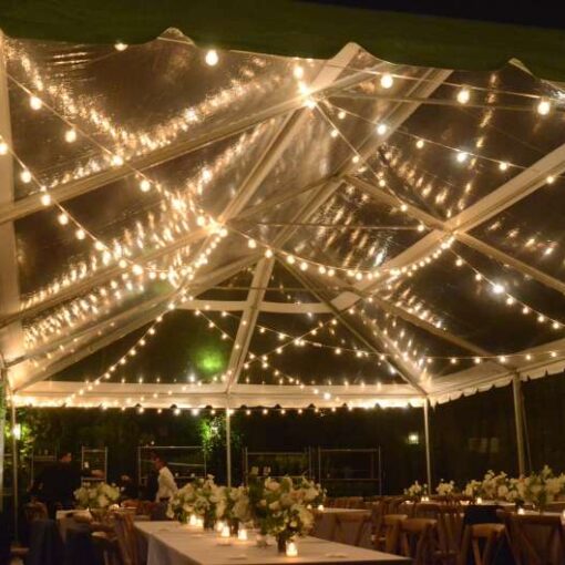 Warm White String Lights hanging in a random zigzagging pattern under a clear top tent for a wedding in the courtyard at The Foundry.