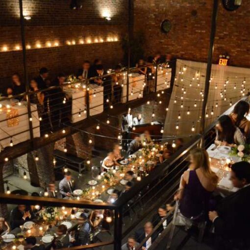 Warm White String Lights hanging in a zig-zag pattern across the mezzanine in the main room.