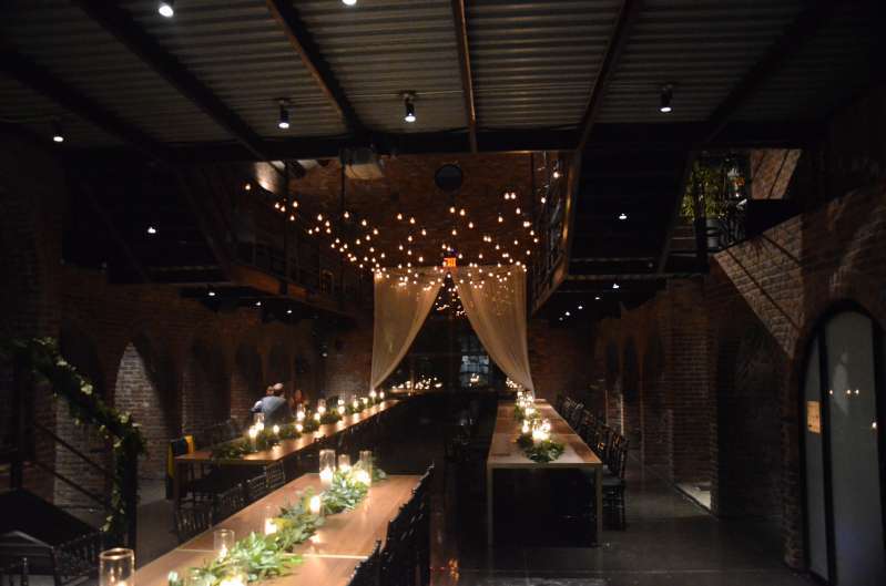 Warm White String Lights hanging in the main room in a zigzagging pattern for a wedding at The Foundry.