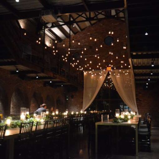 Warm White String Lights hanging in the main room in a zigzagging pattern for a wedding at The Foundry.
