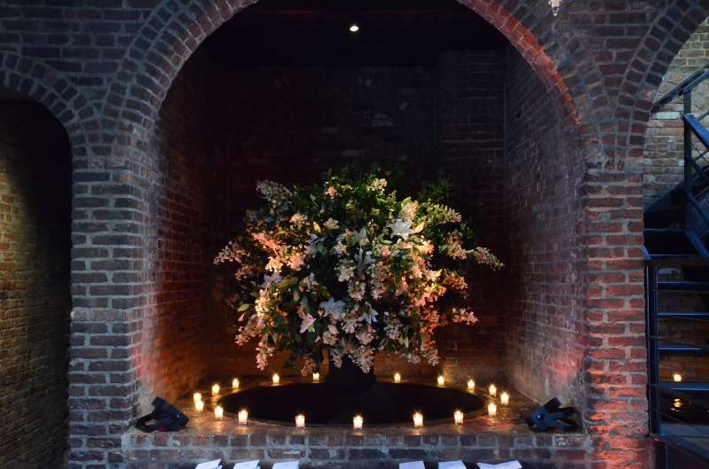 Amber Up-Lights placed inside the first alcove for a wedding in the main room at The Foundry.