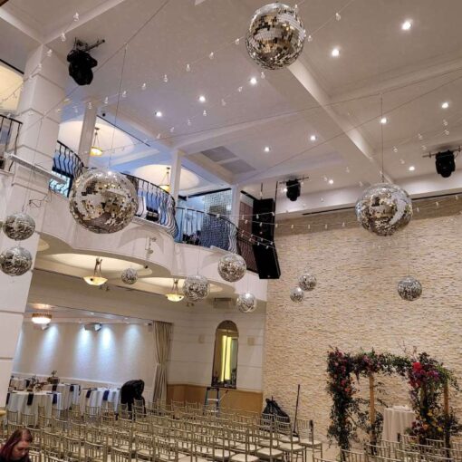 A cluster of mirror balls suspended above the ceremony and dance floor area at The Renaissance Event Hall located in Queens, NY.
