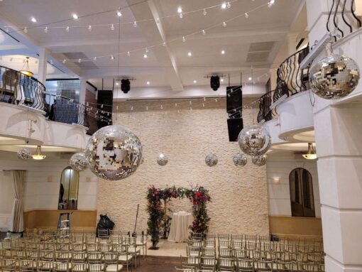A cluster of mirror balls suspended above the ceremony and dance floor area at The Renaissance Event Hall located in Queens, NY.