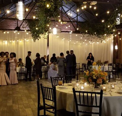 Warm White String Lights hanging in a zigzagging pattern above the main floor at 26 Bridge.