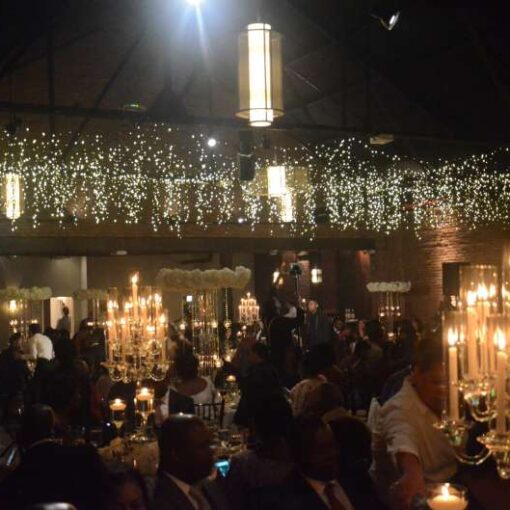 Icicle Lights / Fairy Lights hanging between the 3rd and 4th beam in the main room for a wedding at 26 Bridge.