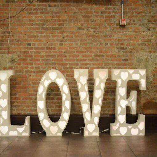 An LED LOVE marquee sign in the foyer at 26 Bridge.