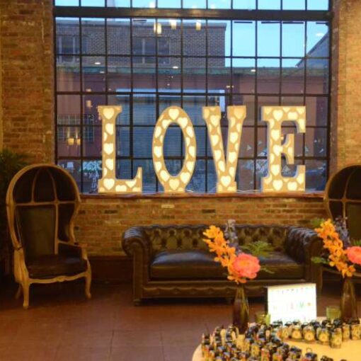 An LED LOVE marquee sign in the foyer at 26 Bridge.