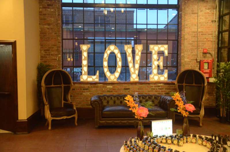 An LED LOVE marquee sign in the foyer at 26 Bridge.