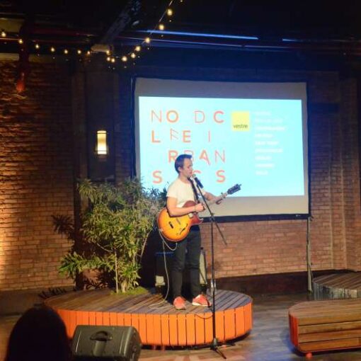 A projector and Screen with String Lights and Warm White Up-Lights for an event at 26 Bridge.