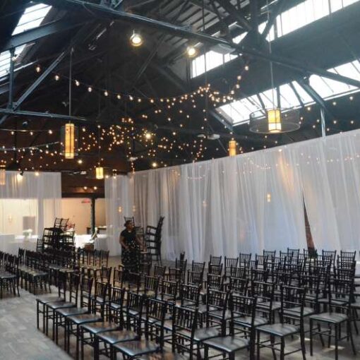 Warm White String Lights hanging in a two circular patterns for a wedding at 26 Bridge (Brooklyn, NY)