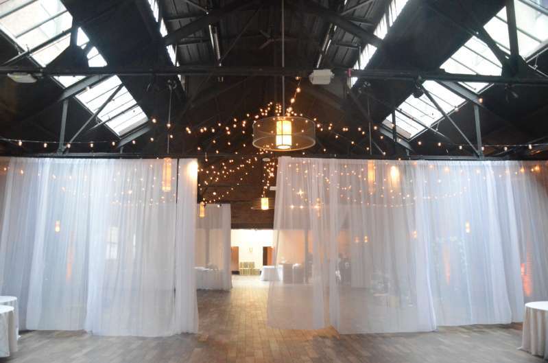 White Sheer curtains hanging in the main room at 26 Bridge.