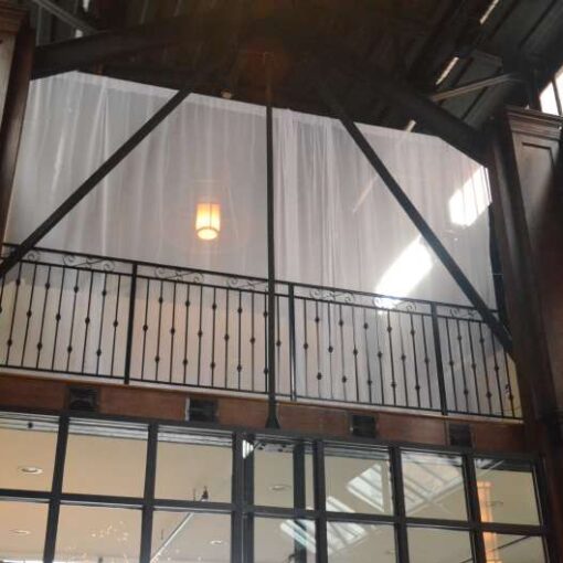 White Sheer curtains are hanging on the mezzanine level at 26 Bridge.