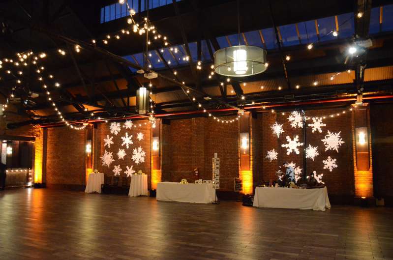 String lights in two circular patterns (Carnival Tent Style Pattern) over the majority of the main floor at 26 Bridge. Also, Amber Up-Lights around the perimeter of the room. Finally, four stock gobo images (textured wash) of snowflakes were projected on the wall for a holiday party.