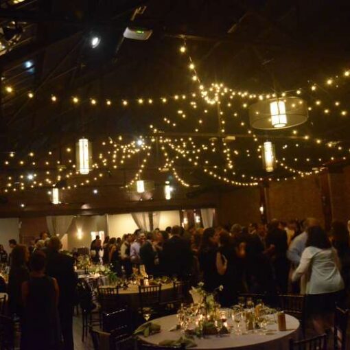 Warm White String Lights hanging in a two circular patterns for a wedding at 26 Bridge (Brooklyn, NY)