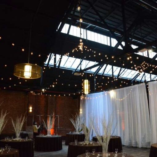 String Lights with round G50 bulbs hanging in two circular patterns in the main room at 26 Bridge. 
