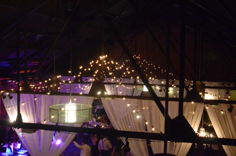 String Lights with round G50 bulbs hanging in two circular/star shape above the main floor at 26 Bridge.