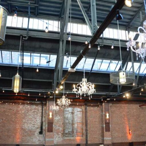 String Lights in a ZigZag pattern over dance floor at 26 Bridge. Along with four chandeliers. Also, Up-Lights around the perimeter wall.