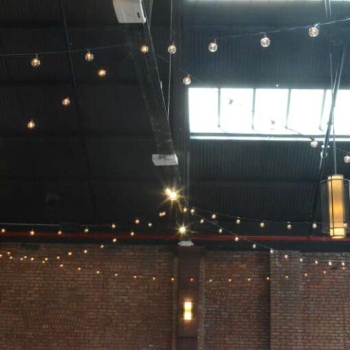 String Lights with S14 Bulbs hanging in a zigzag pattern for a wedding at 26 Bridge. 