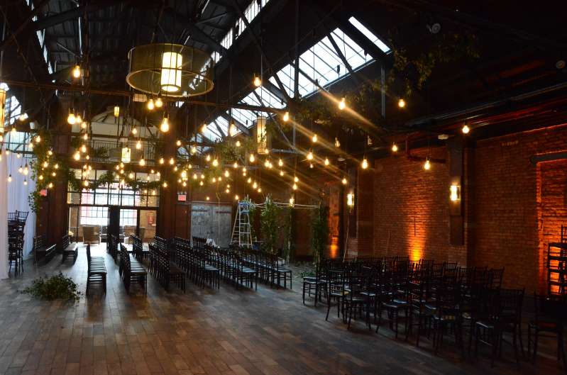 Pendant lamps with vintage antique Edison bulbs are hanging over the dance floor at 26 Bridge. Also, amber up-lights are along the perimeter wall of the main room.