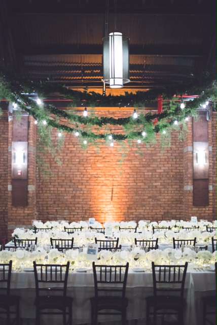 String Lights hanging in Parallel lines over the length of the main room for a wedding at 26 Bridge.