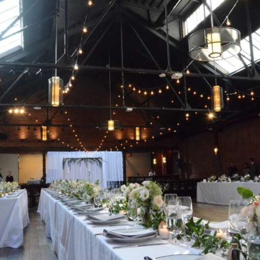 String Lights in V-Shape pattern above the main room for a wedding at 26 Bridge.