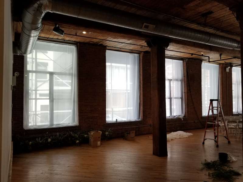 White sheer curtains hanging in windows for a wedding at The Dumbo Loft.