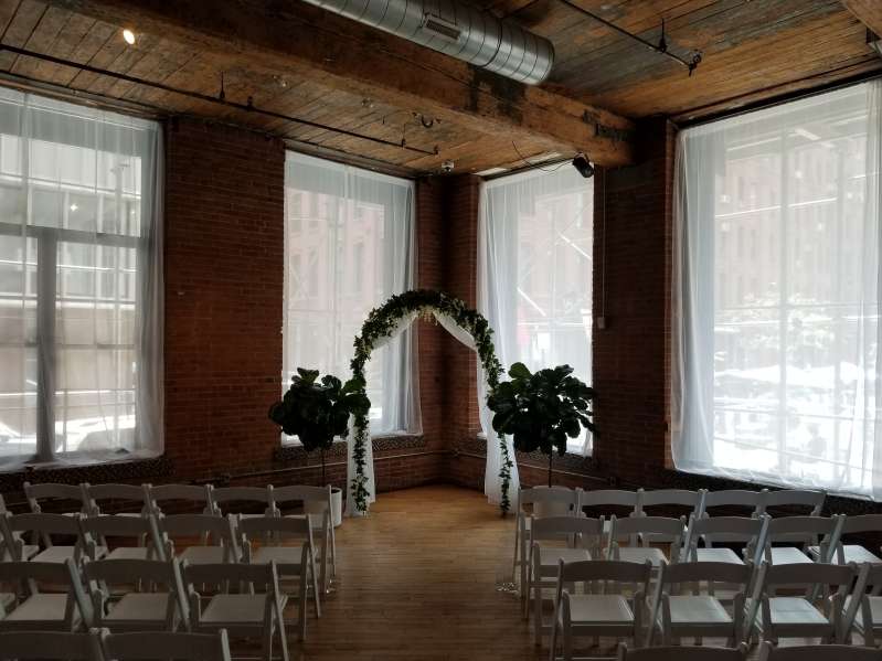 White sheer curtains hanging in windows for a wedding at The Dumbo Loft.