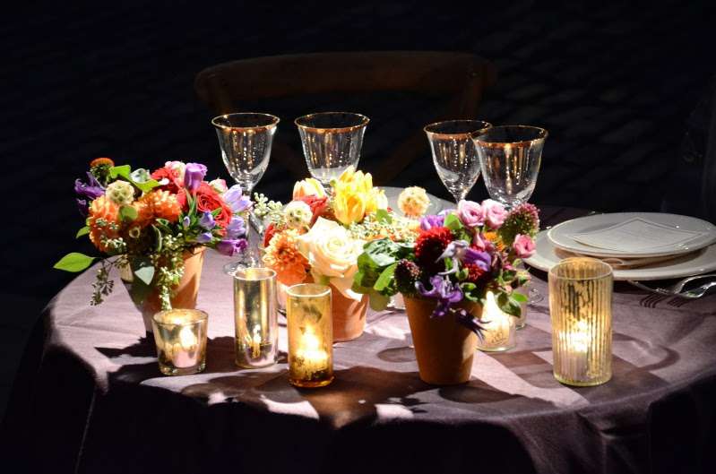 Pin-Spots are highlighting the table centerpieces on diner tables under a clear-top tent at The Foundry.