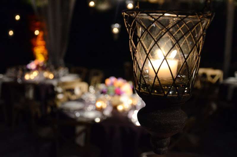 French Wire Candle Holders are hanging under a clear-top tent for a wedding at The Foundry.