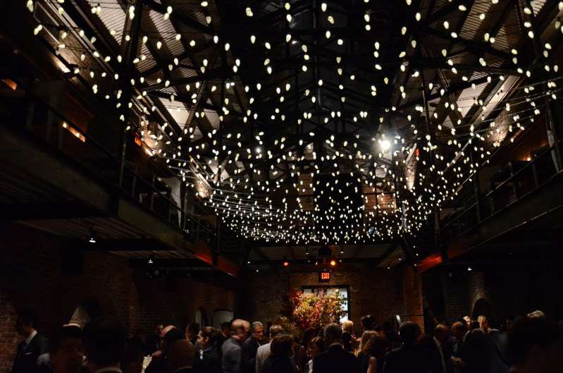 A canopy of mini LED string lights (twinkle) is hanging in the main room for a wedding at The Foundry.
