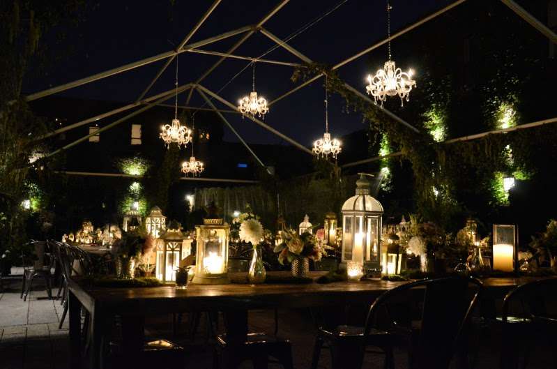 Chandeliers hanging under a tent frame in the courtyard for a wedding at The Foundry.
