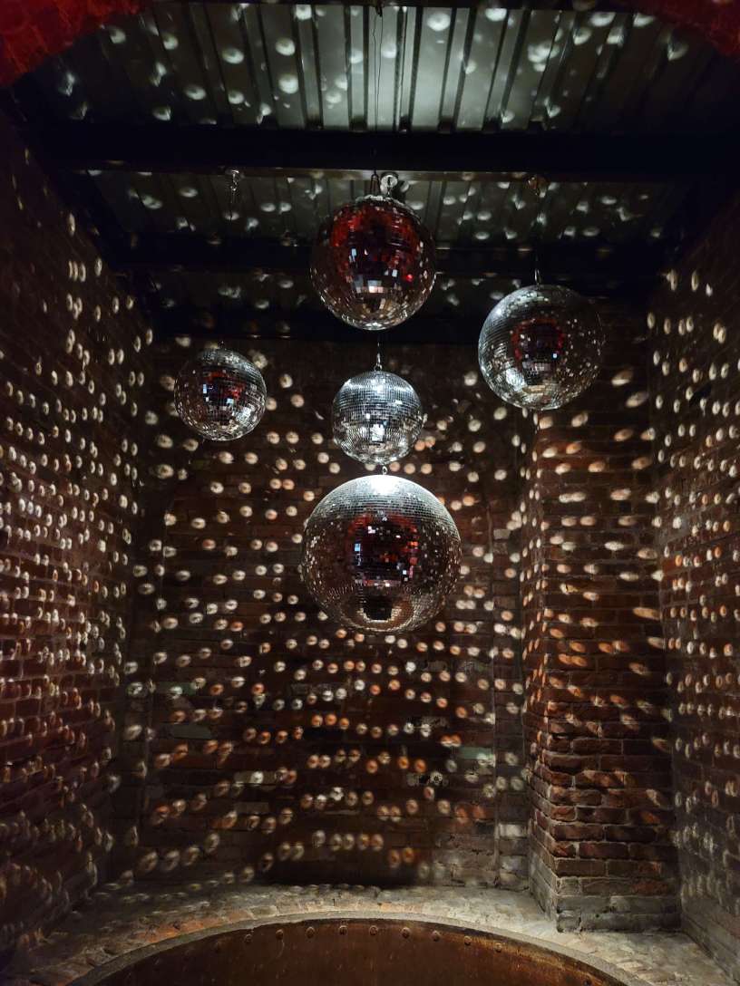 A chandelier of mirror ball hanging in the 1st alcove at The Foundry