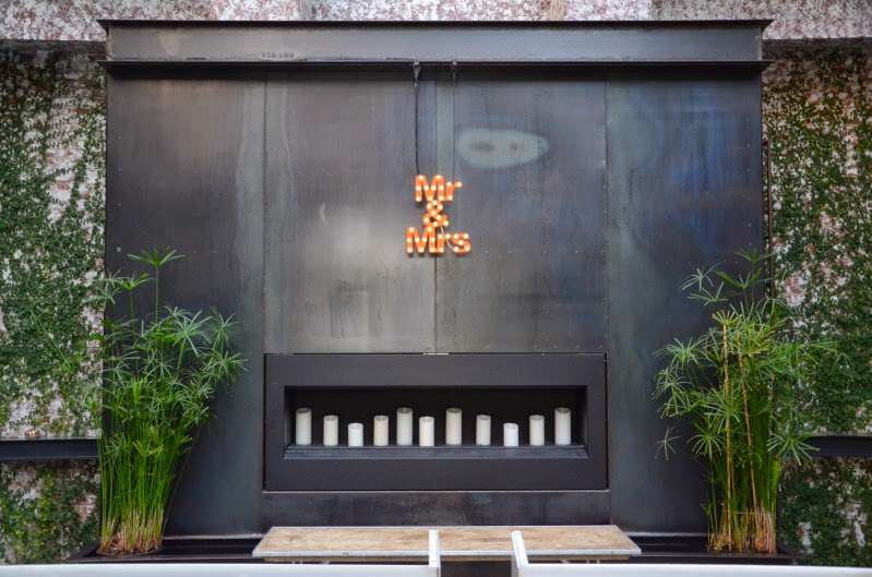 A custom Marquee (provided a client) hanging over The fireplace in The Greenhouse at The Foundry.