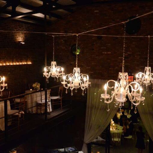 Chandeliers hanging in the main room for a wedding at The Foundry.