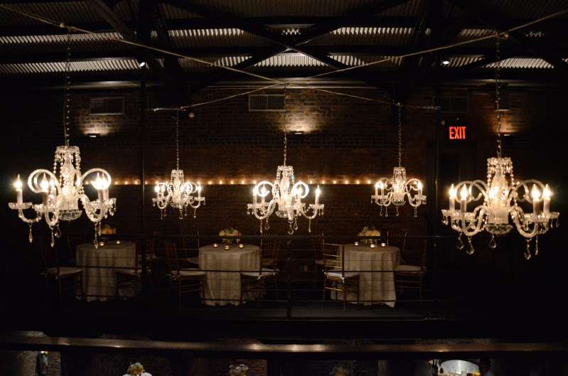 Chandeliers hanging in the main room for a wedding at The Foundry.