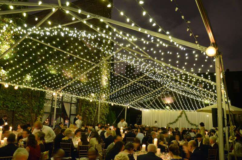 A canopy of Mini LED String Lights (Twinkle) hanging under a tent frame for a wedding in The Courtyard at The Foundry.