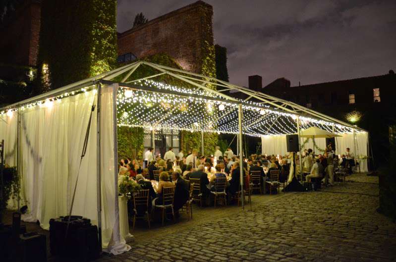 A canopy of Mini LED String Lights (Twinkle) hanging under a tent frame for a wedding in The Courtyard at The Foundry.