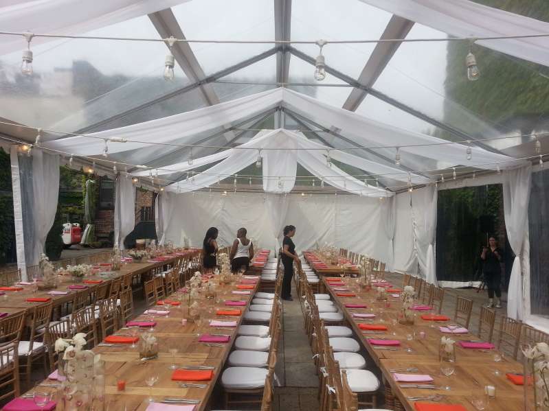 Market Lights hanging under a clear top tent for a wedding in the courtyard at The Foundry.