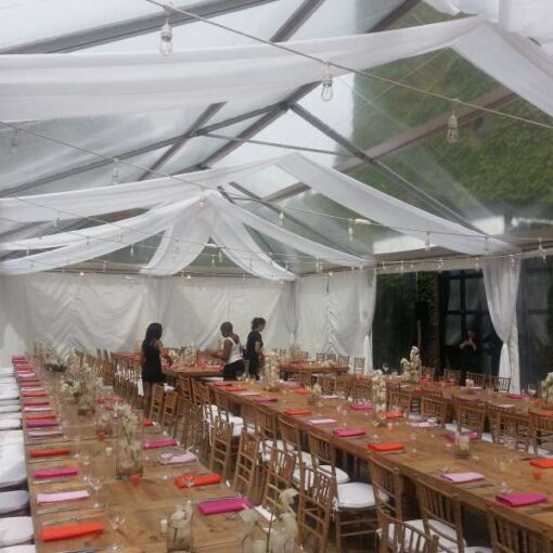 Market Lights hanging under a clear top tent for a wedding in the courtyard at The Foundry.