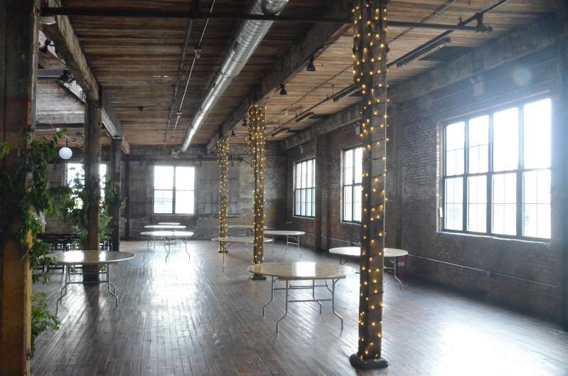 Twinkle Lights wrapped around three columns for a wedding in the main room at The Greenpoint Loft.
