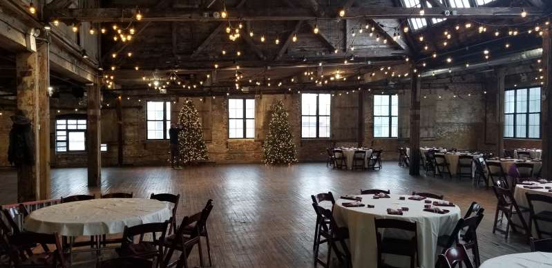 String Lights hanging in a zigzagging pattern between the six center columns for a wedding in the main room at The Greenpoint Loft.