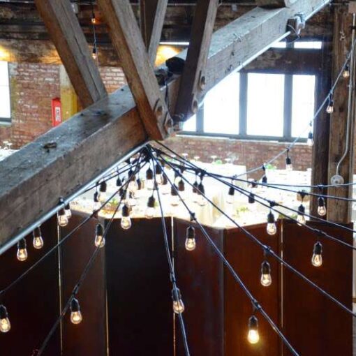 String Lights hanging in a circular pattern between the center columns at The Greenpoint Loft