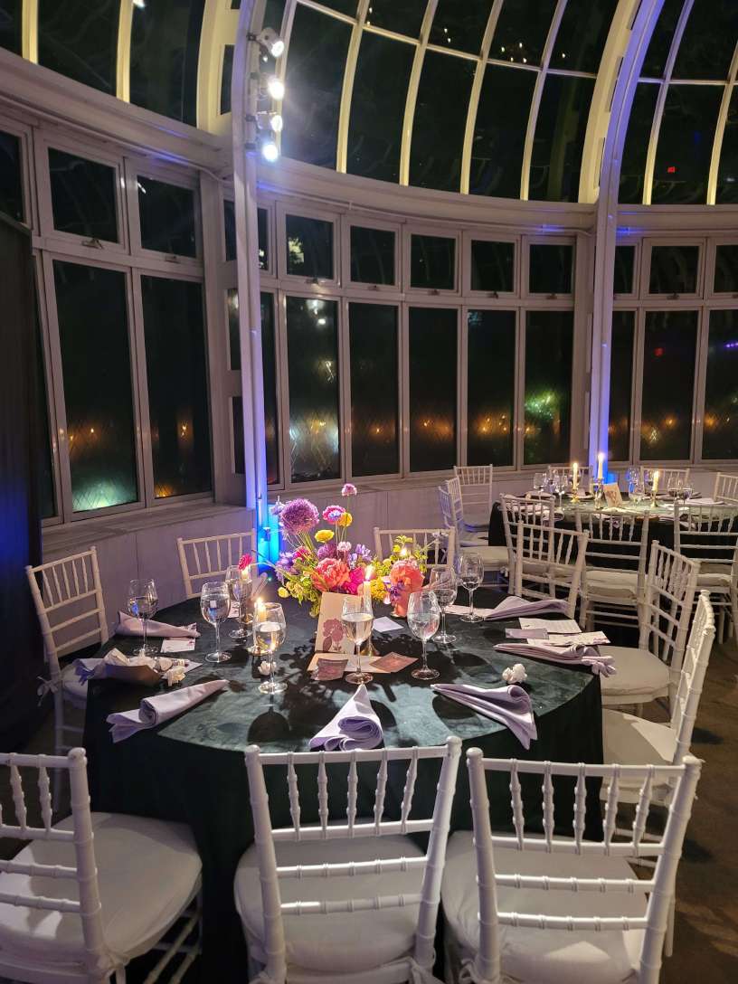 A Pin-Spot highlighting a table centerpiece inside The Palm House for a wedding.
