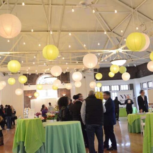 String lights hanging with White and Lime Green paper lanterns for a wedding at The Prospect Park Picnic House.