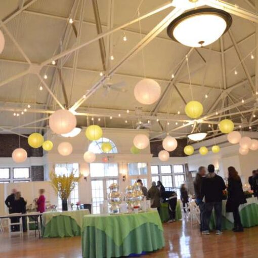 String lights hanging with White and Lime Green paper lanterns for a wedding at The Prospect Park Picnic House.