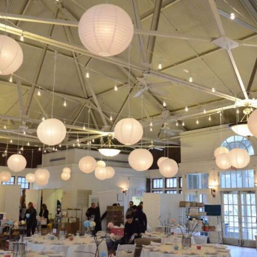 A combination of String Lights and 40 Paper Lanterns hanging in the main room at The Prospect Park Picnic House.
