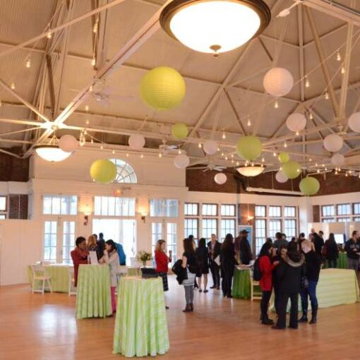 Approximately 25 Lime Green and White Paper Lanterns hanging from zigzagging string lights in The Prospect Park Picnic House.