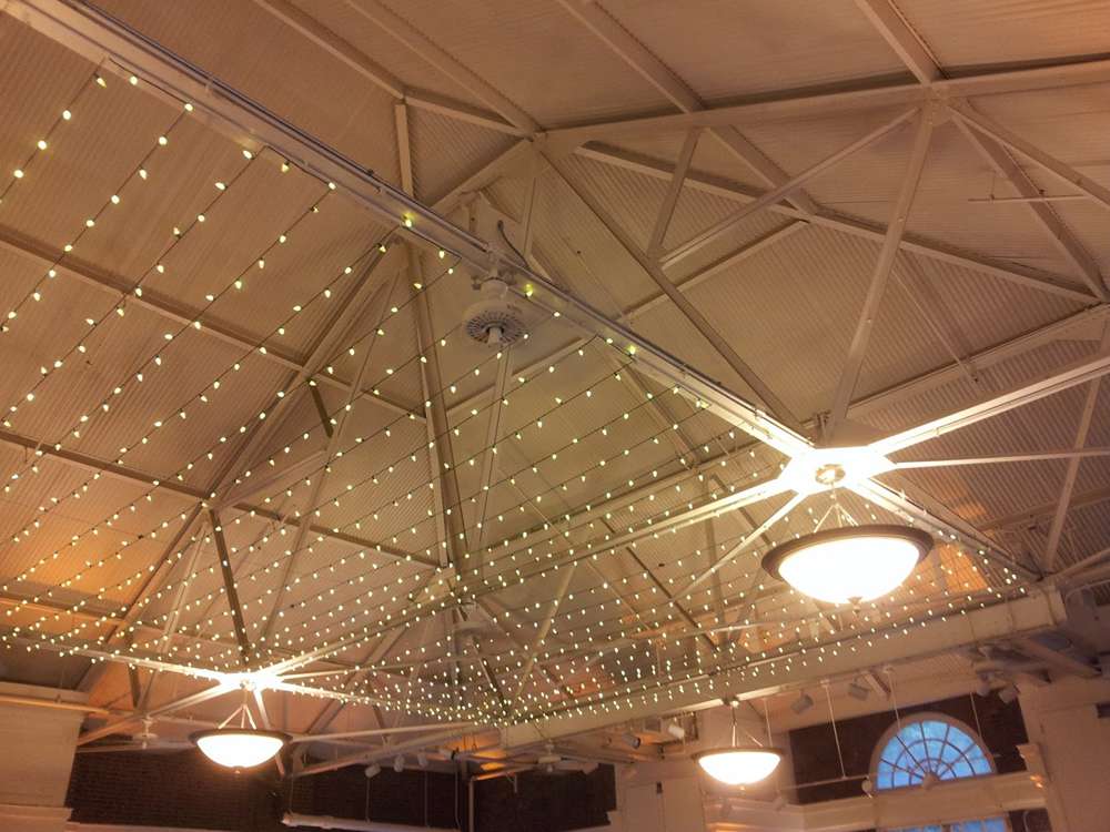 A canopy of Twinkle Lights hanging over the main floor for a wedding at The Prospect Park Picnic House.